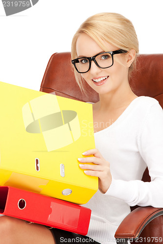 Image of young businesswoman with folders sitting in chair