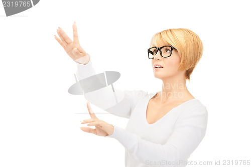 Image of businesswoman working with something imaginary 