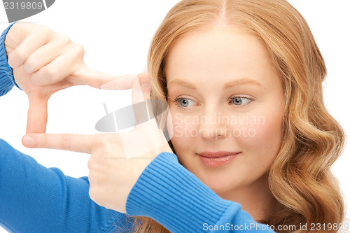 Image of lovely woman creating a frame with fingers