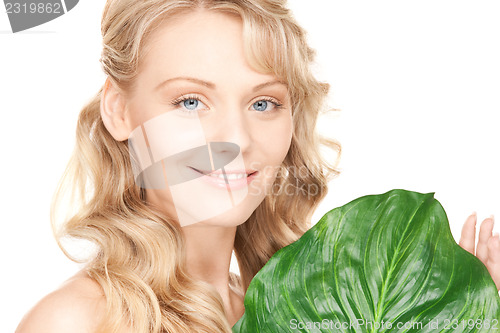 Image of woman with green leaf