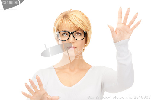 Image of businesswoman working with something imaginary 
