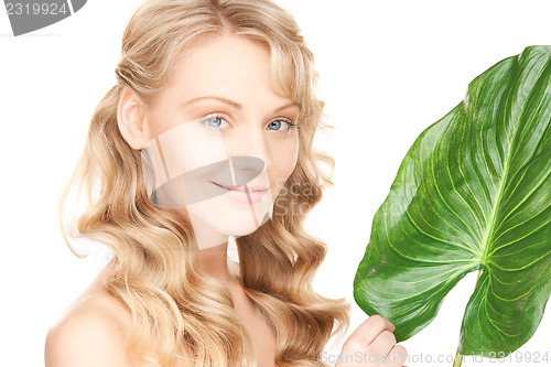 Image of woman with green leaf