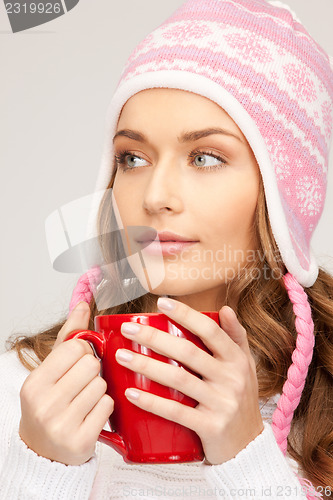 Image of beautiful woman with red mug