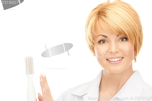 Image of doctor with toothbrush