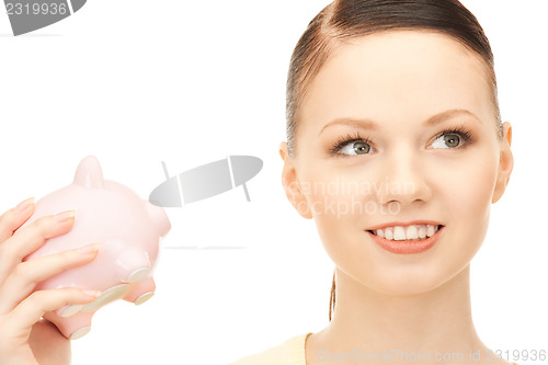 Image of  lovely woman with piggy bank	 