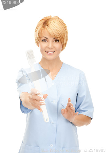 Image of doctor with toothbrush