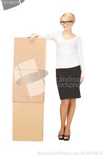 Image of  attractive businesswoman with big boxes	 