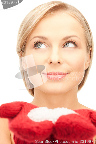 Image of beautiful woman in red mittens with snow