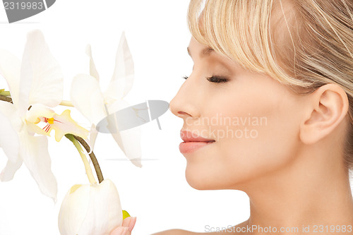 Image of beautiful woman with orchid flower 