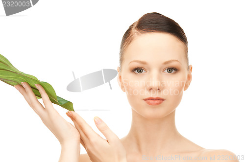 Image of woman with green leaf