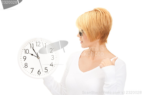 Image of woman holding big clock