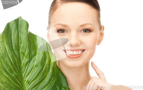 Image of woman with green leaf