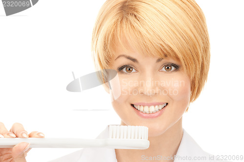 Image of doctor with toothbrush