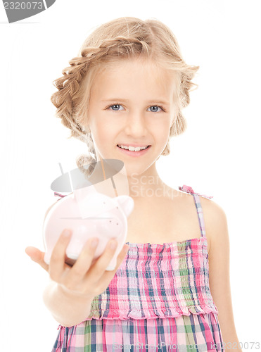 Image of little girl with piggy bank