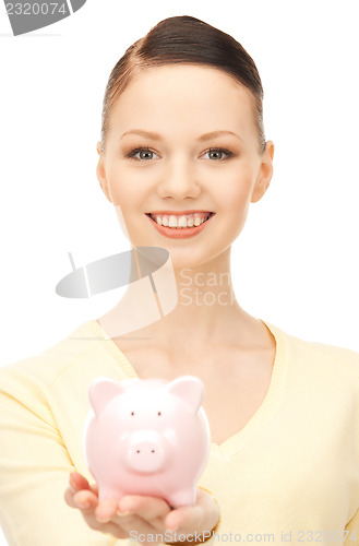 Image of  lovely woman with piggy bank	 