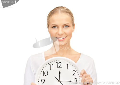 Image of woman holding big clock