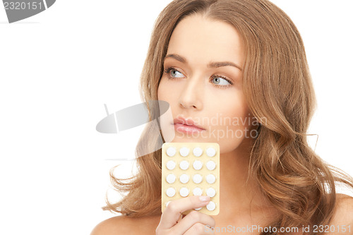 Image of young beautiful woman with pills 