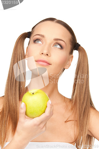 Image of young beautiful woman with green apple