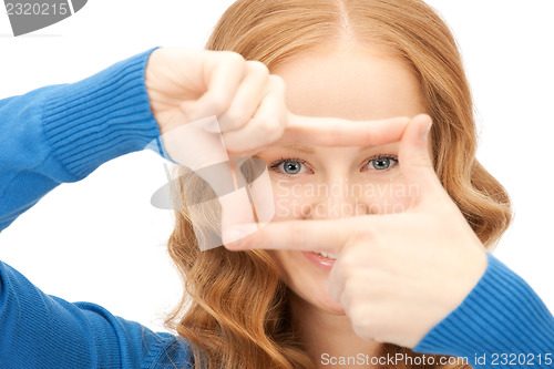 Image of lovely woman creating a frame with fingers