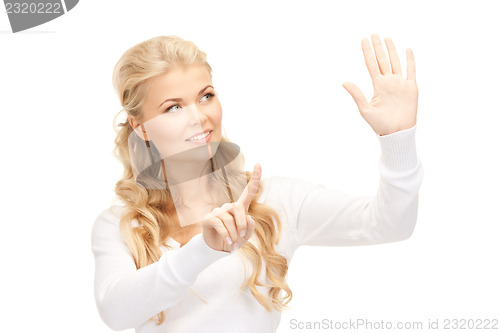 Image of businesswoman working with something imaginary