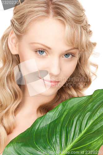 Image of woman with green leaf