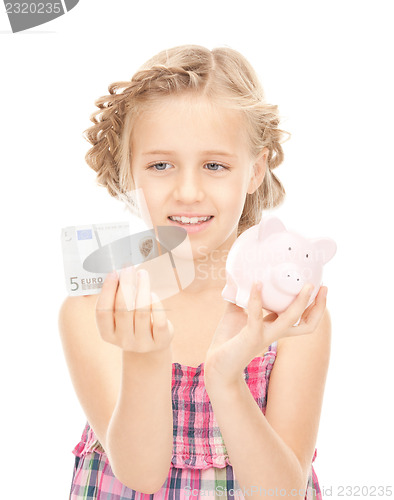 Image of little girl with piggy bank and money