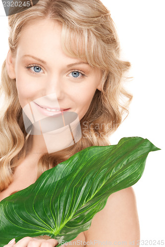 Image of woman with green leaf