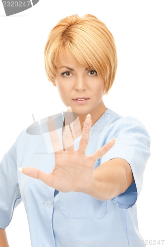 Image of attractive female doctor showing stop gesture