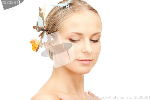 Image of beautiful woman with butterfly in hair