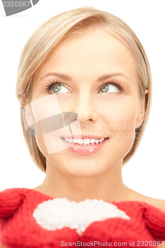 Image of beautiful woman in red mittens with snow