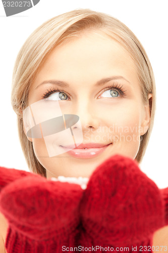 Image of beautiful woman in red mittens with snow