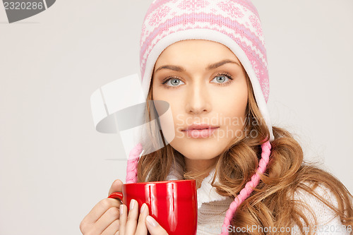 Image of beautiful woman with red mug