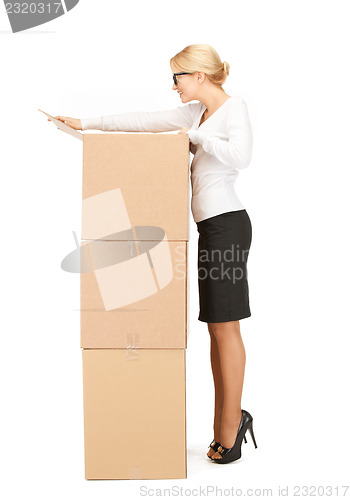 Image of  attractive businesswoman with big boxes	 