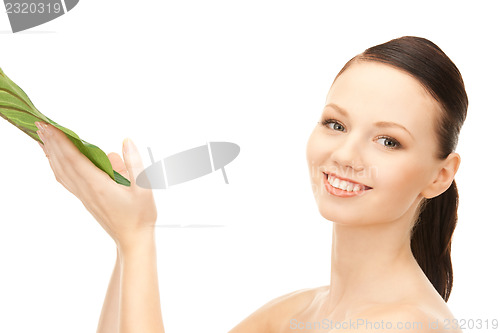 Image of woman with green leaf
