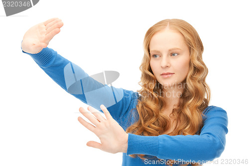 Image of businesswoman working with something imaginary