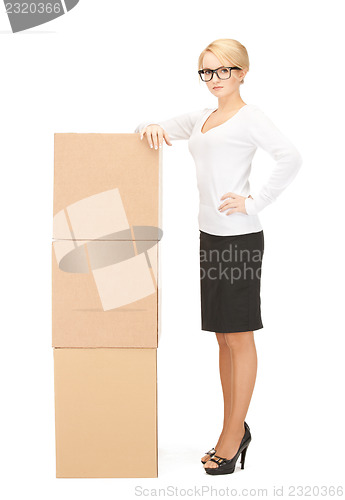 Image of  attractive businesswoman with big boxes	 