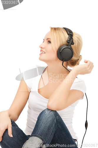 Image of  happy teenage girl in big headphones