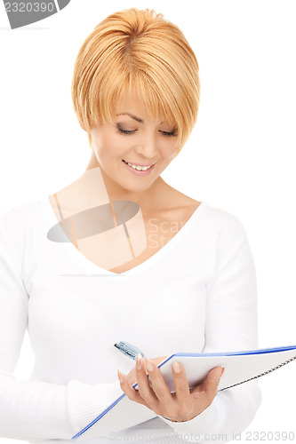 Image of attractive businesswoman with notebook