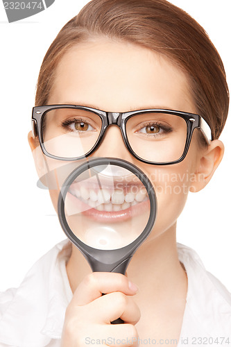 Image of woman with magnifying glass showing teeth