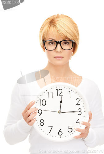 Image of woman holding big clock