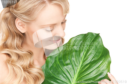 Image of woman with green leaf