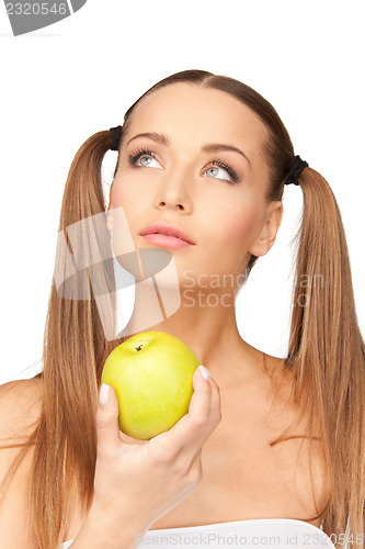 Image of young beautiful woman with green apple