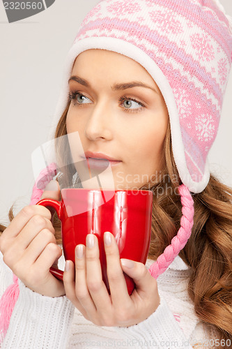 Image of beautiful woman with red mug