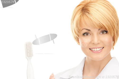 Image of doctor with toothbrush