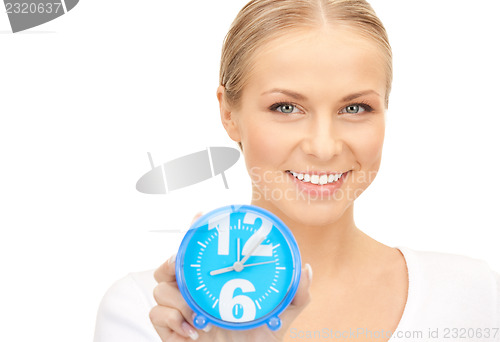 Image of woman holding alarm clock