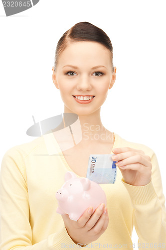 Image of lovely woman with piggy bank 