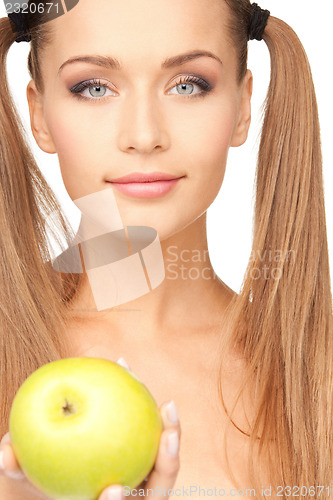 Image of young beautiful woman with green apple