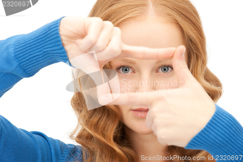 Image of lovely woman creating a frame with fingers