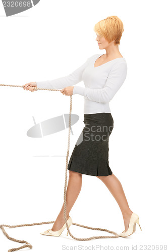 Image of business woman pulling rope