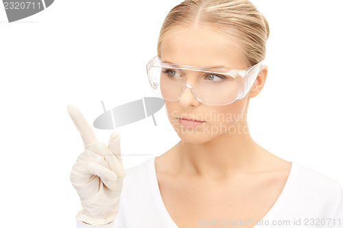 Image of woman in protective glasses and gloves